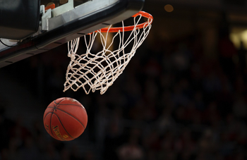 Basketball being shot through basketball hoop