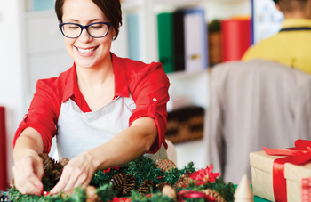 Woman decorating holiday wreath