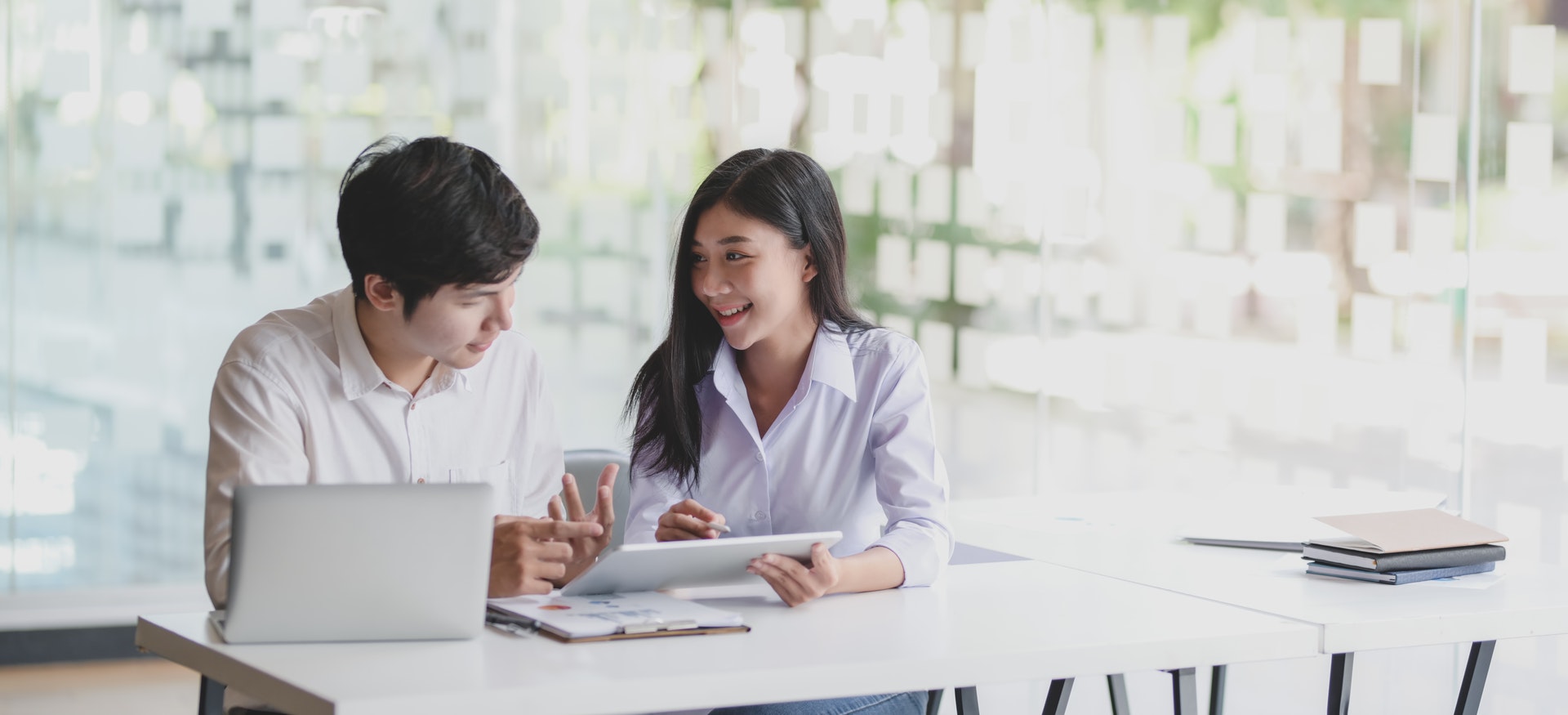 couple sitting at table looking at documents