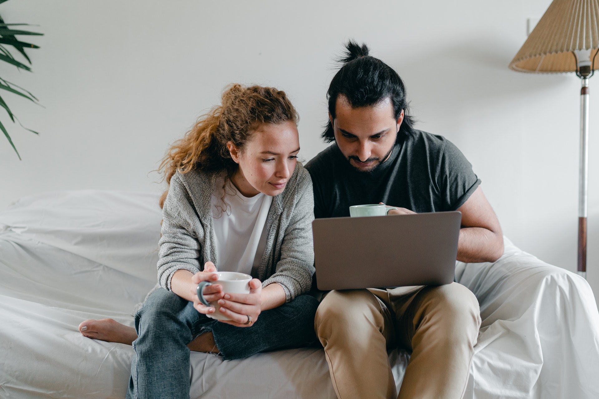 man and woman looking at computer