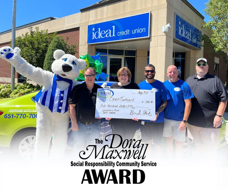 bucky bear and friends presenting large check donation to Open Cupboard food shelf