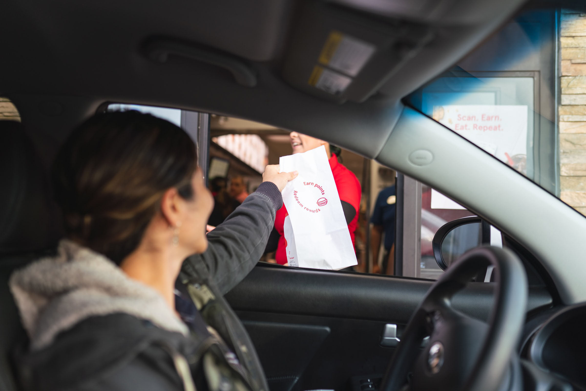 woman in car picking up food