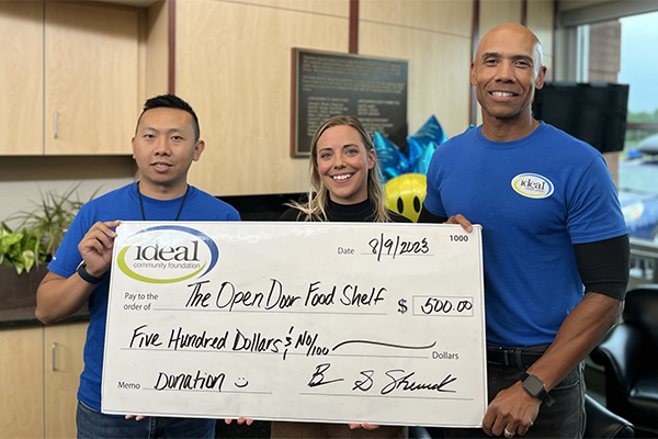 Ideal Staff present large $500 check to The Open Door Food Shelf