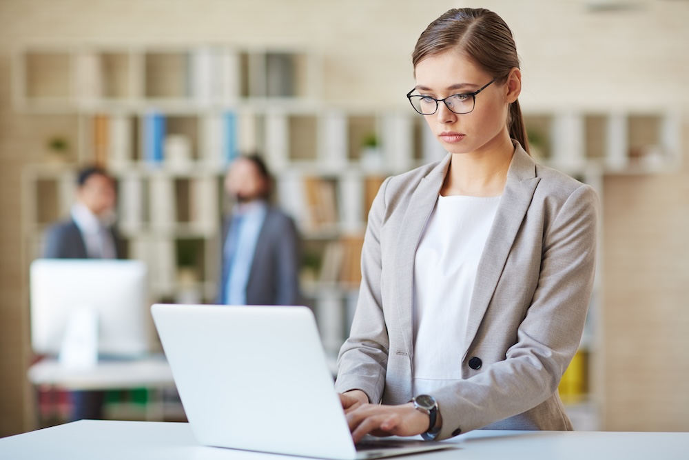 woman typing new password into computer